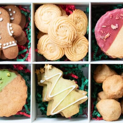 Overhead view of a box of festive Christmas cookies.