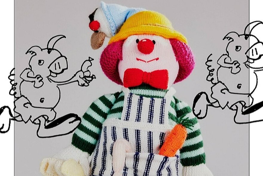 A soft, knitted clown with yellow hat, green striped shirt and blue and white apron with a carrot in the pocket, overlaid with hand drawn cartoon creatures.