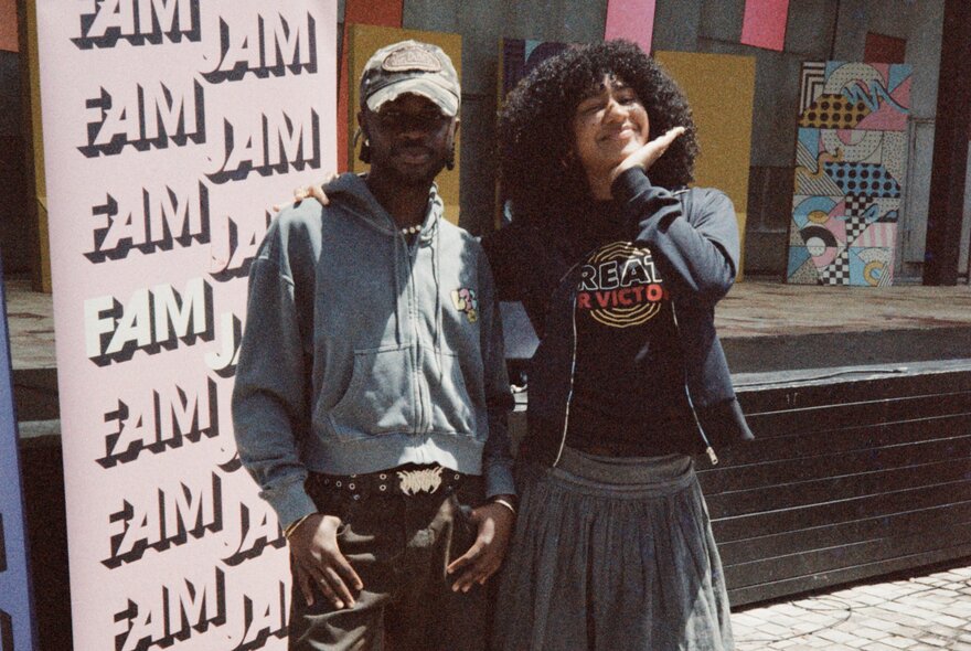 Two dancers wearing hip-hop caps and hoodies.