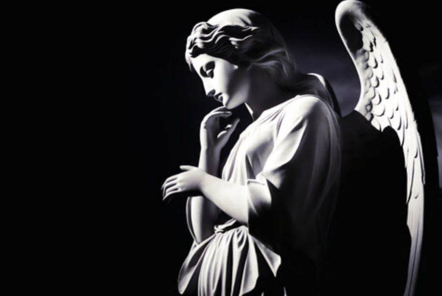 Dramatic black-and-white profile of the famous neo-classical marble sculpture known as the Monteverde Angel.