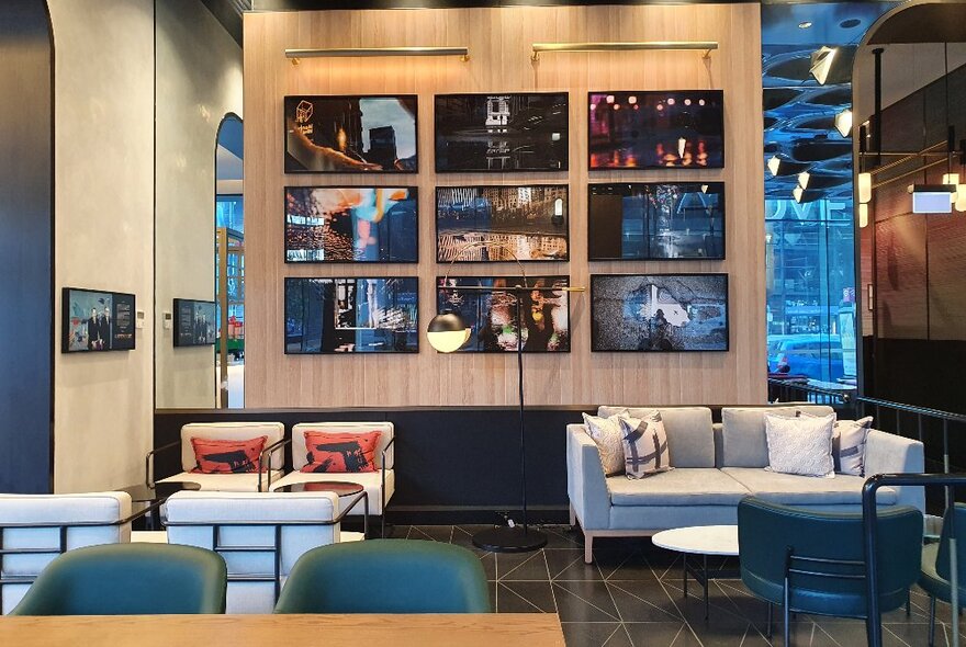 Cafe interior with couches and tables, with decorative shelves in the background.