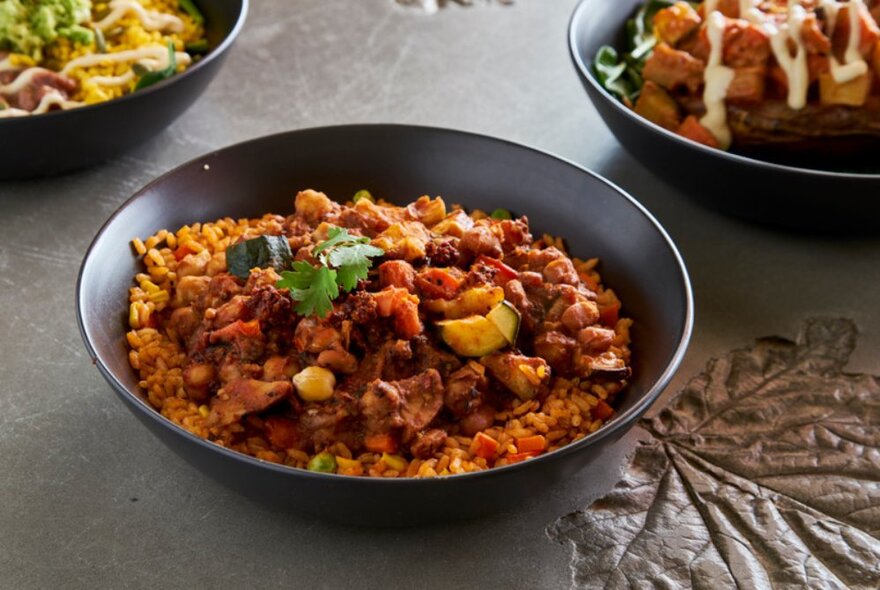 Bowls of Mexican food on a stone table. 