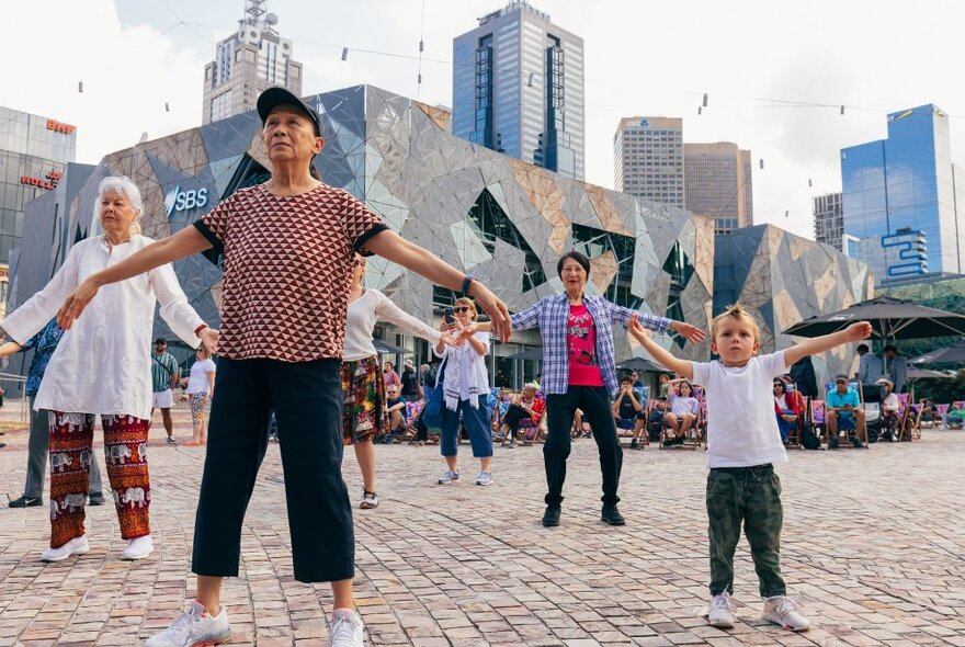 People participating in a Tai Chi class at Fed Square.