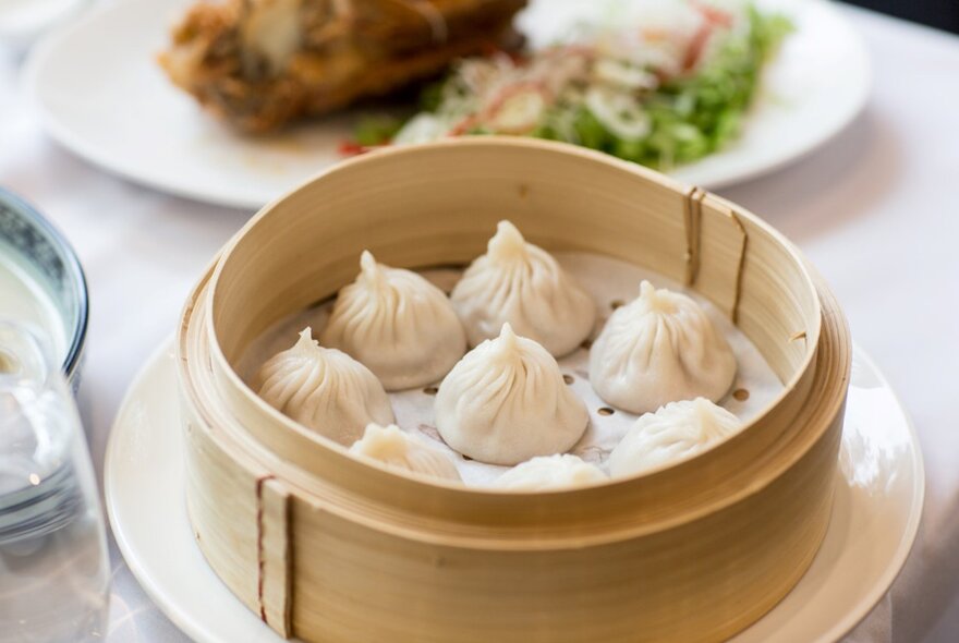 A steamer basket full of soup dumplings
