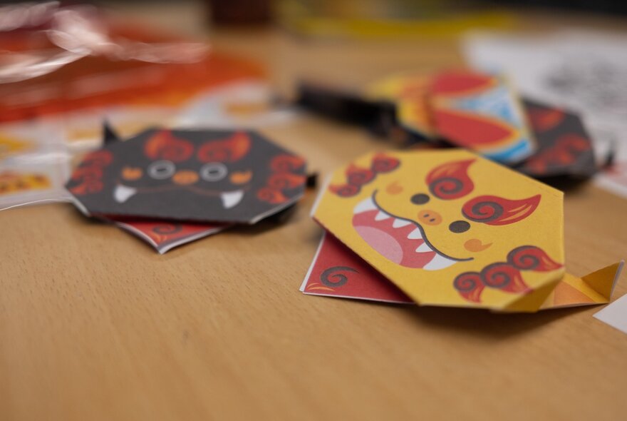 Paper Japanese animal masks on a desk.