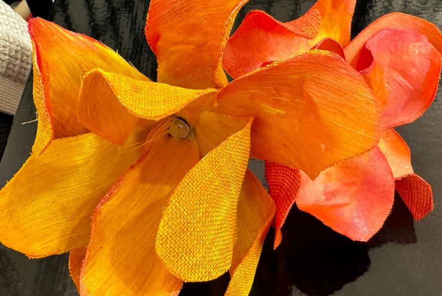 Yellow hand painted silk petals arranged in a flower formation.