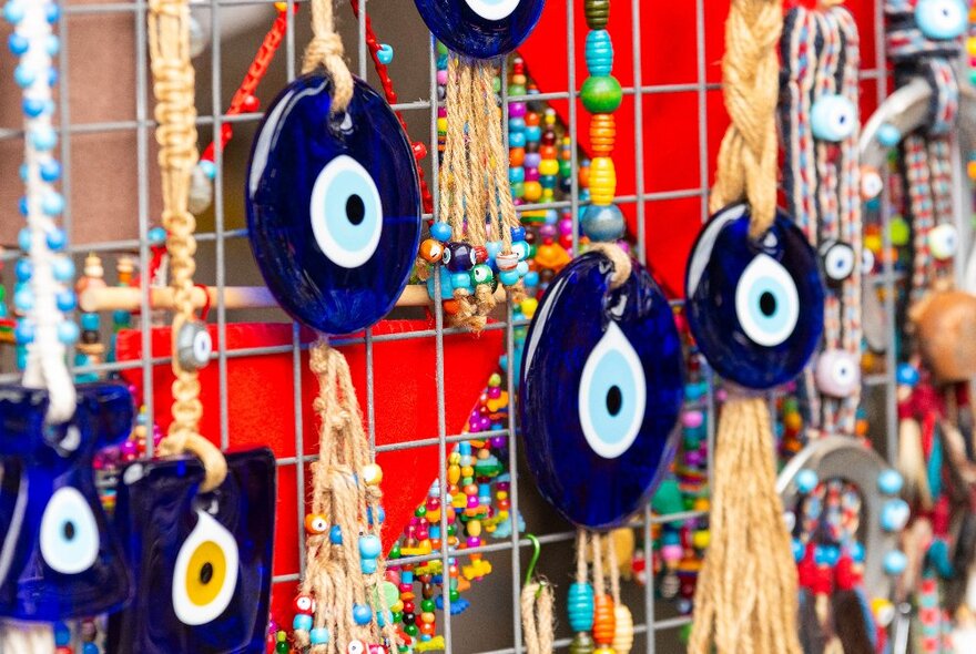 Glass tokens and jewellery on display at a stall selling Turkish handicrafts.