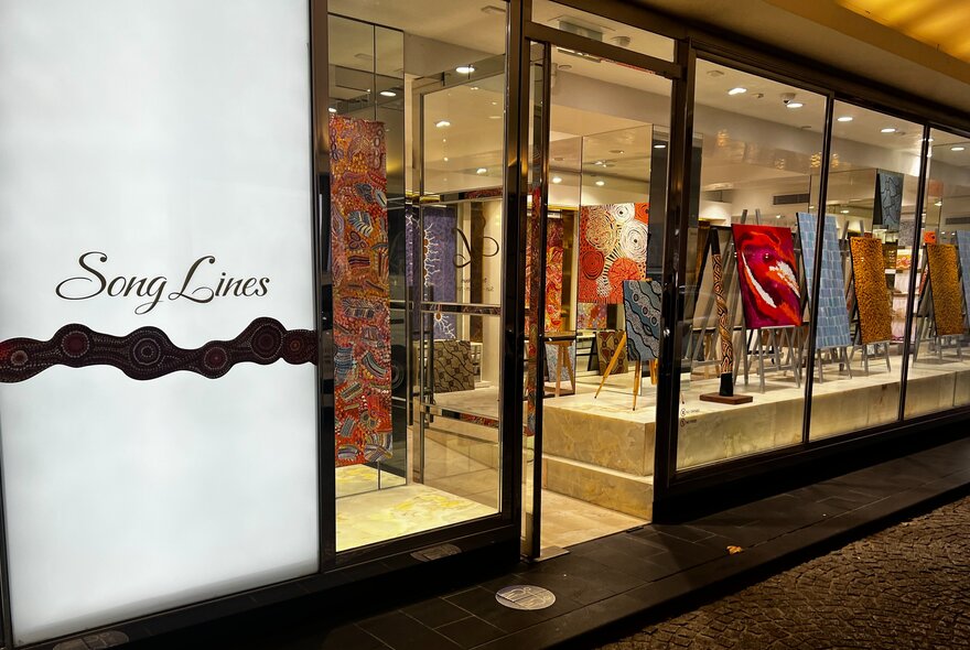The exterior of SongLines Gallery with artwork on display in the window.