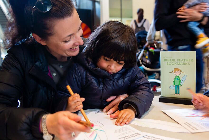 A parent and child taking part in a craft activity at Melbourne Museum.