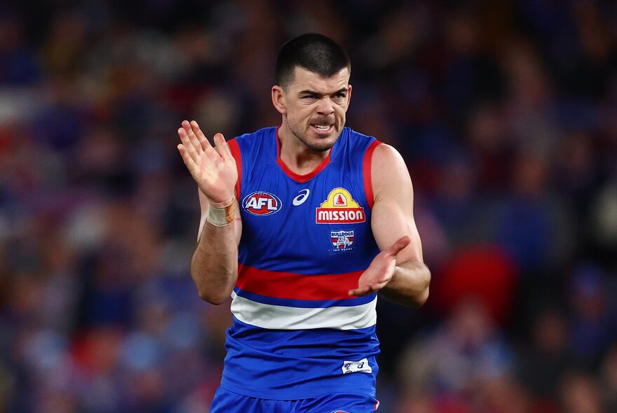 Western Bulldog AFL football player clapping hands during a match.