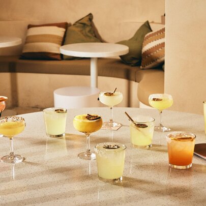 A range of margarita cocktails on a round table.