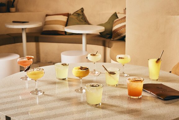 A range of margarita cocktails on a round table.