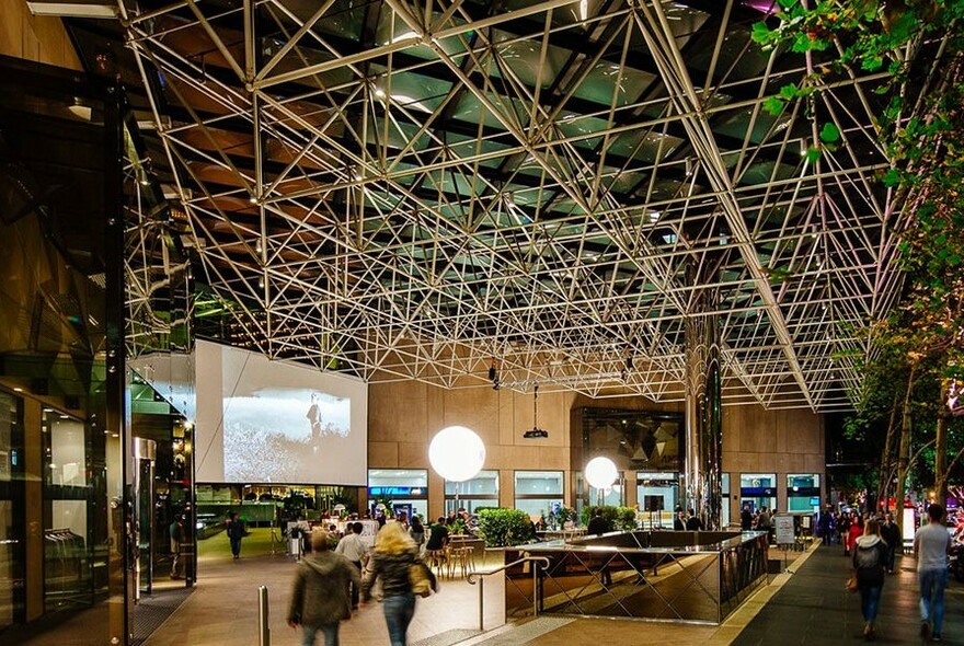 Collins Place atrium. with large screen.