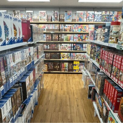 Rows of board games and puzzles on shelves.