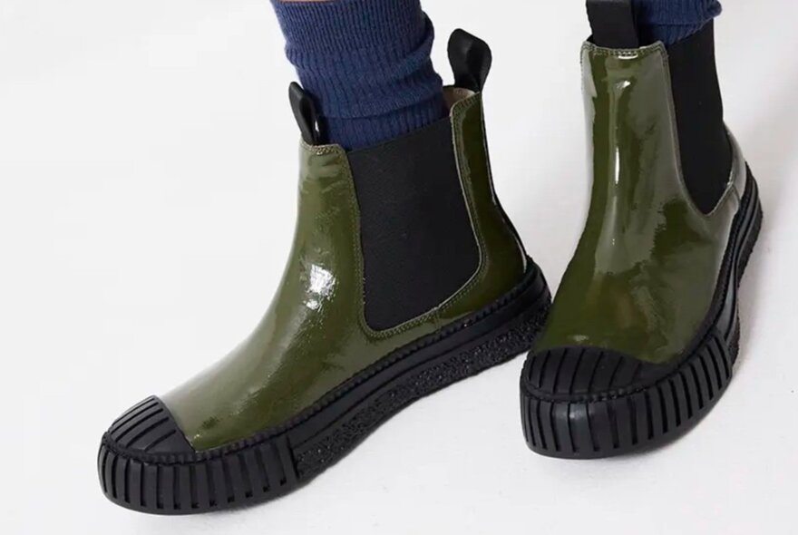 A pair of patent leather green boots
