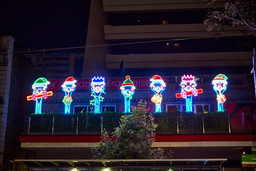Light up display of seven emus eating. 