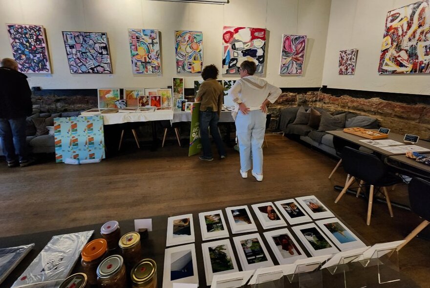 Large room with artwork on walls and floor.