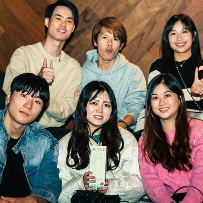 A group of six people in two tiers posing and smiling. 