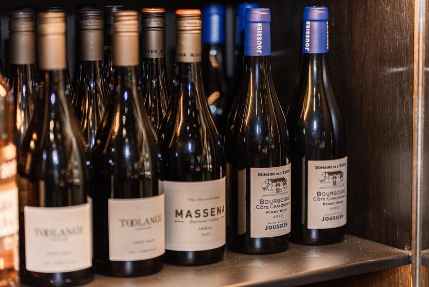 Bottles of wine on a shelf.