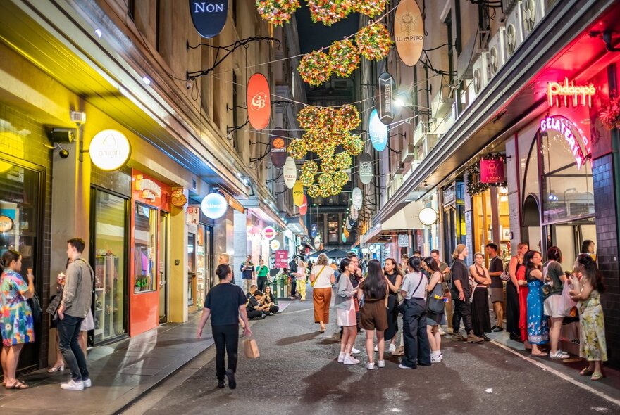 Christmas decorations light up above Degraves Street. 