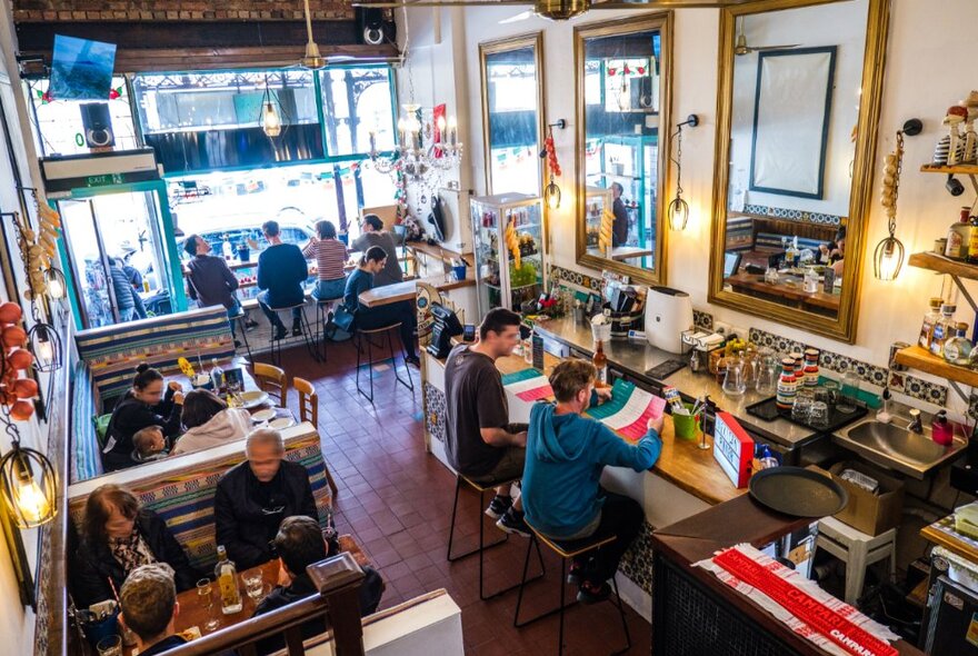 Aerial view of a cosy Mexican restaurant with traditional decor and tiling, and lots of natural light.