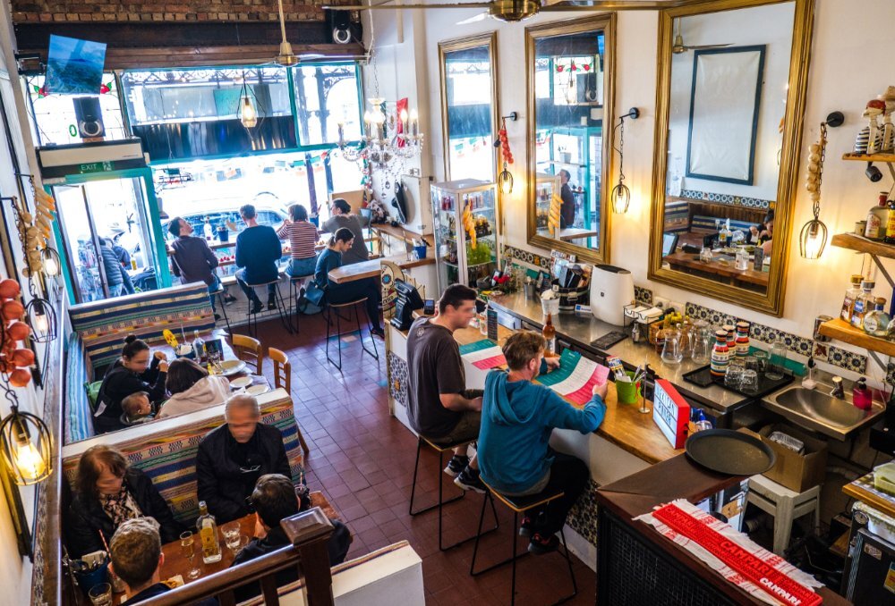 Aerial view of a cosy Mexican restaurant with traditional decor and tiling, and lots of natural light.