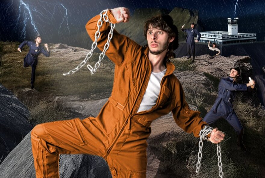 Comedian and mime artist Con Coutis, dressed in orange prison overalls, with chains around his wrists, performing a show about escaping from a maximum security prison called Heck Island, with prison and escape motifs in the background.