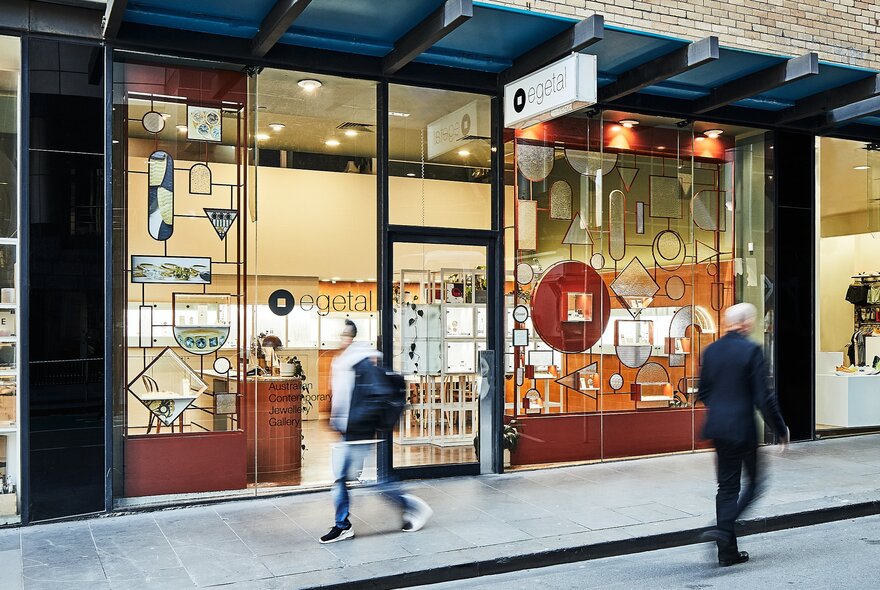 An exterior, street-level photograph of e.g.etal, a contemporary jewellery gallery, with people walking past.