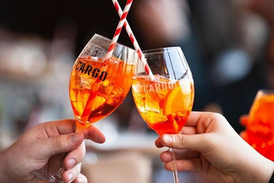 Two orange-coloured drinks in glasses. 