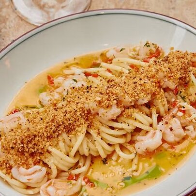 A plate of spaghetti with a creamy prawn sauce.