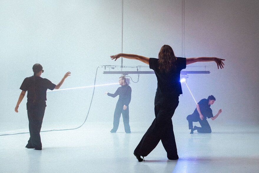 Dancers in a studio space, some with strings on them looking like marionettes. 