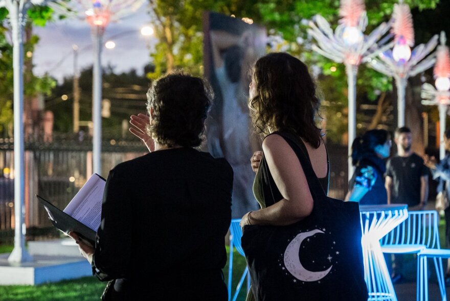 People socialising in the gardens at the Hellenic Museum.