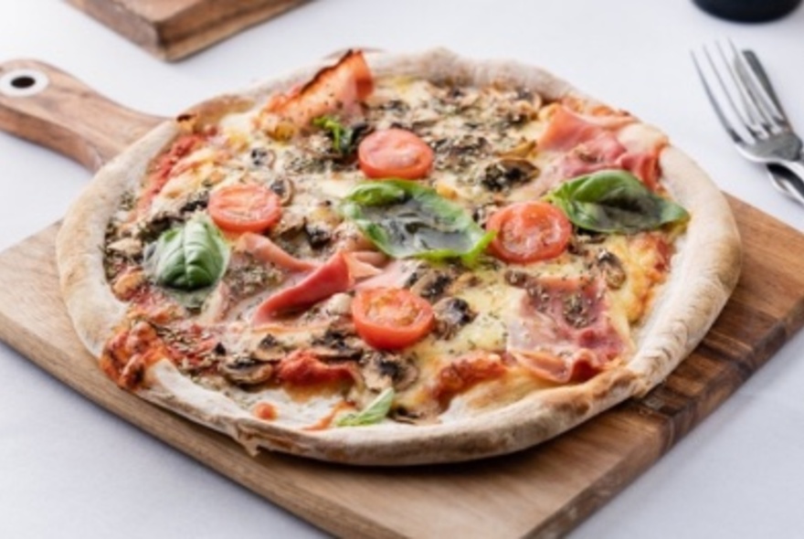 Pizza on a wooden serving board.