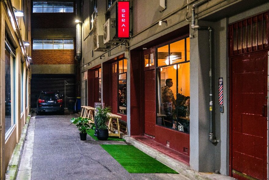 City laneway with the shopfront window exterior of Serai restaurant visible.