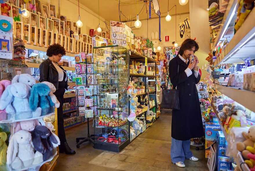 Two friends browsing in a toy shop.