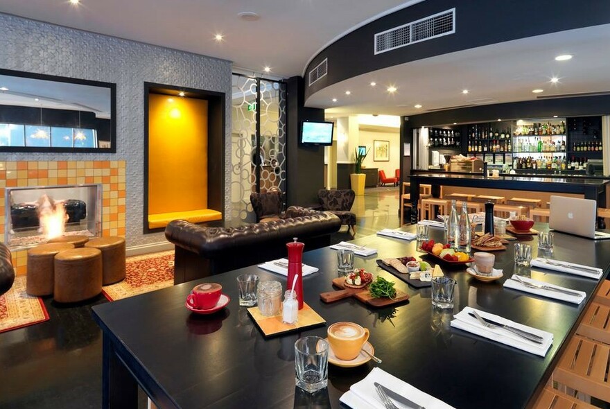 Modern-looking pub with food laid out on a table.