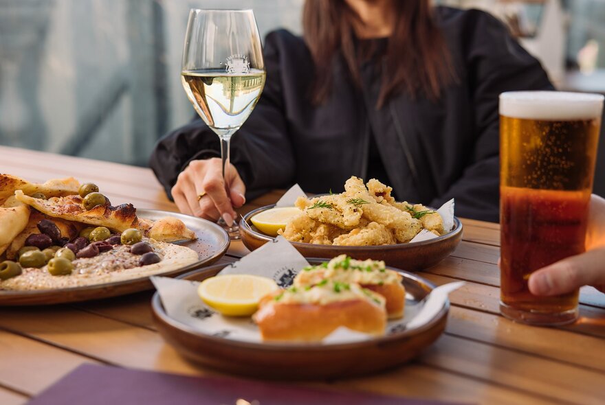 A table with drinks and pub food.