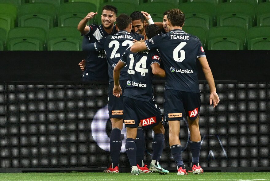 Soccer players in a huddle during a match.