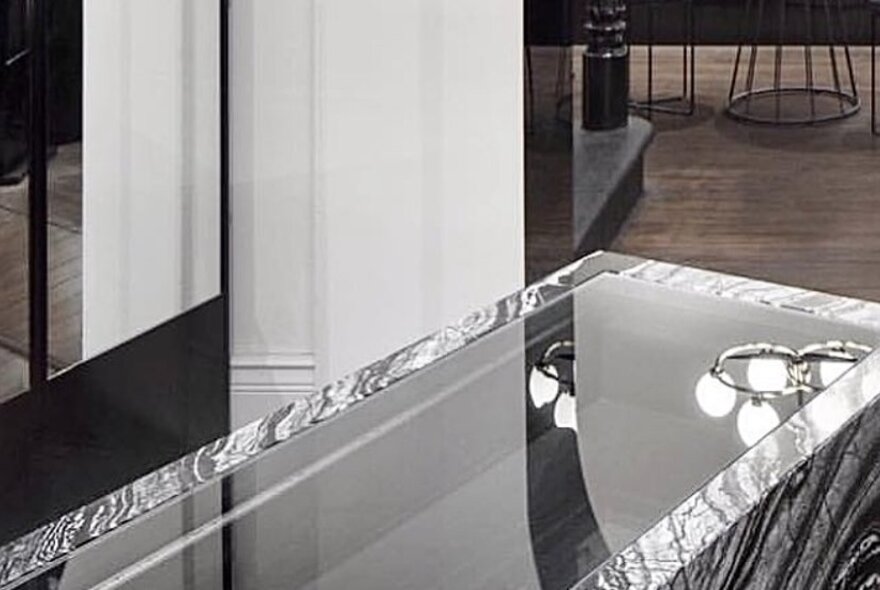 Jewellery store interior with glass-topped marble display case.