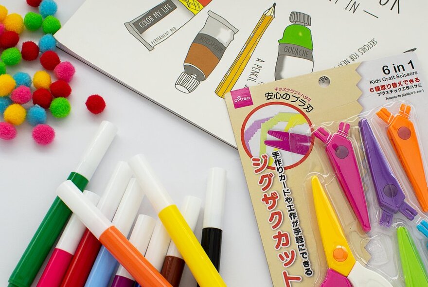 Assorted stationary and craft objects scattered casually. 