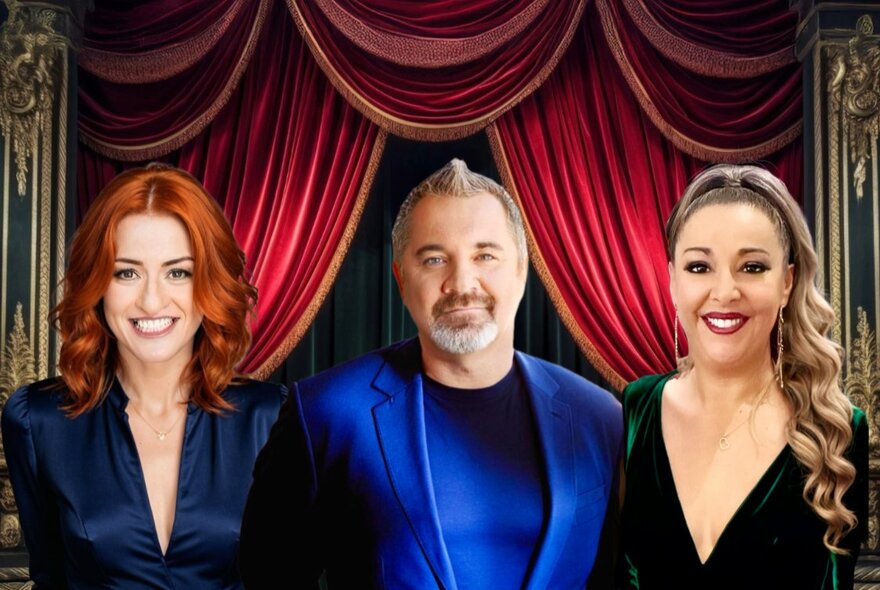 Two women and a man in front of a stage with draped velvet curtains.
