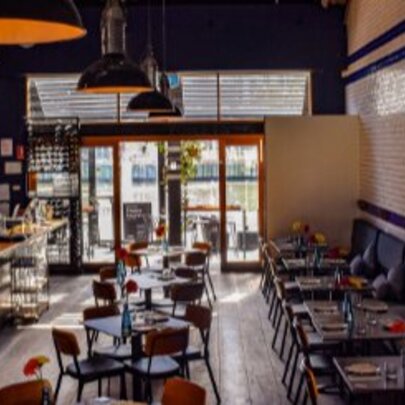 Restaurant interior with bar and dining areas. 