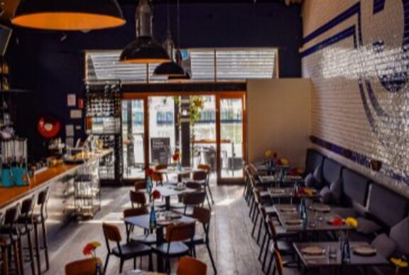 Restaurant interior with bar and dining areas. 