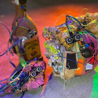 An artwork that features discarded electronic components resembling a robotic creature, part of an exhibition at Science Gallery.