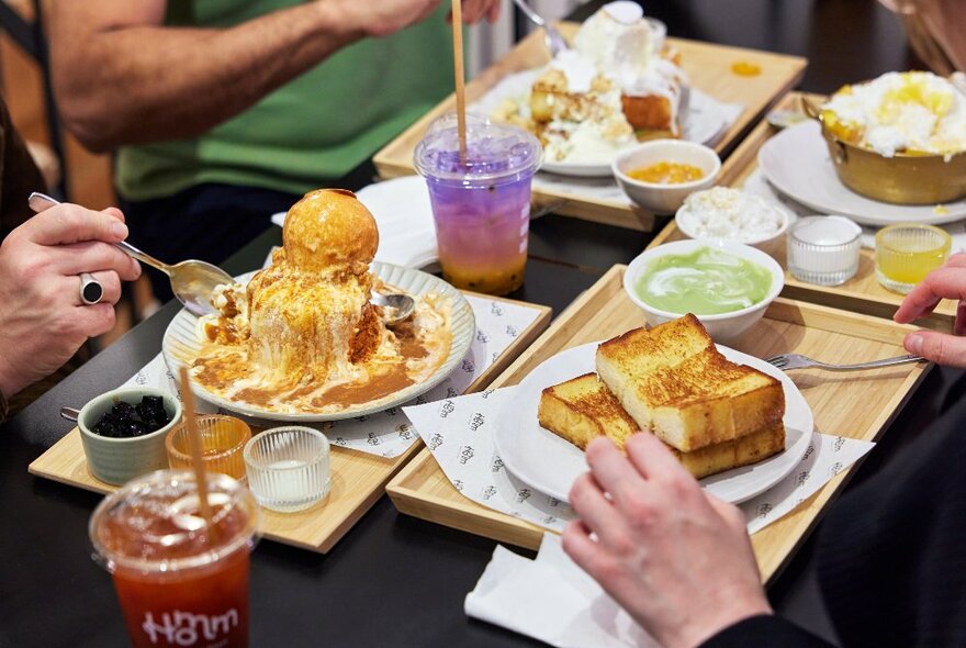 A table with bingsu, kaya toast and fruit drinks