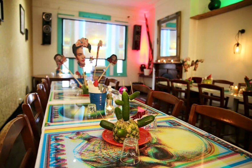 The interior of with brightly painted tables.