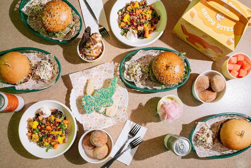 Children's meals including small burgers and bowls of salad.