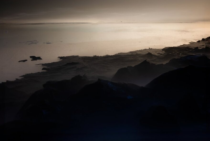 Landscape photographic artwork of a grey seascape at dusk.