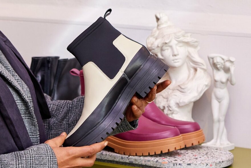 A black and white ankle boot in a shoe shop.