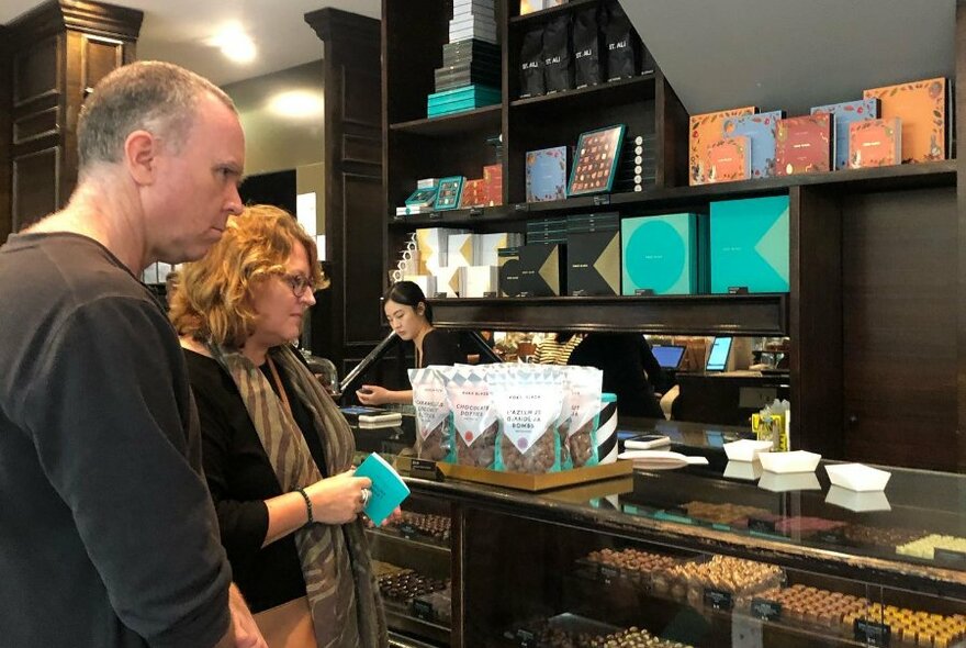 Two people in a chocolate store.